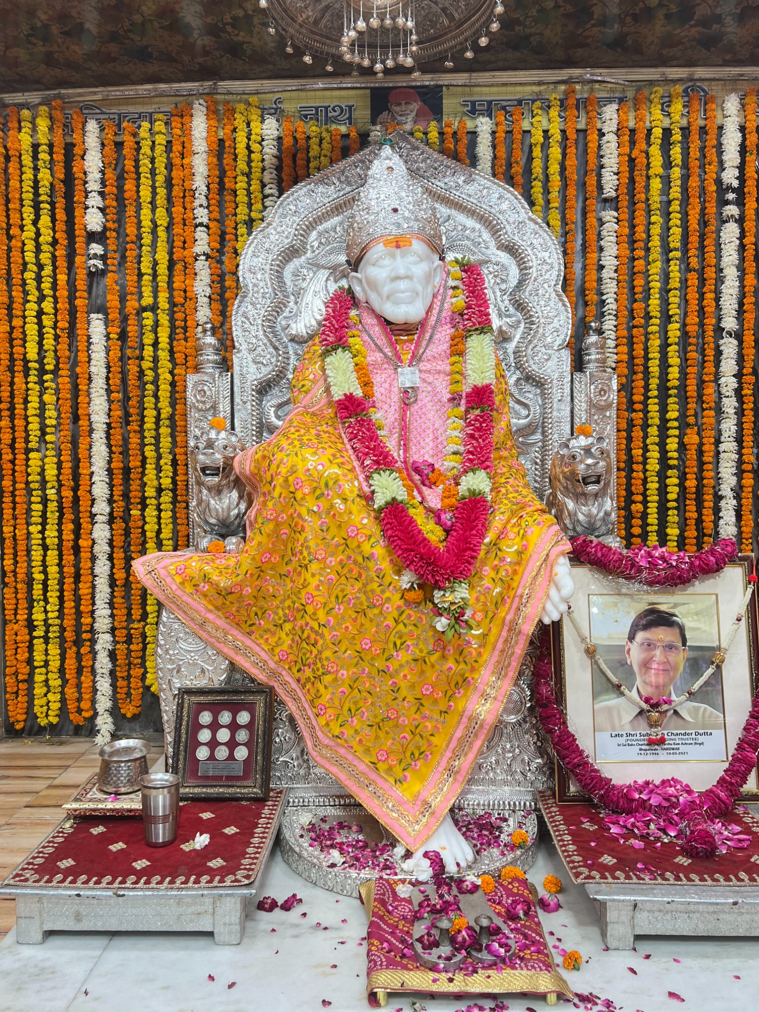 Shri Sai Baba idol on silver Simhasan adorned with marigold garlands at Sai Mandir Bhupatwala Haridwar